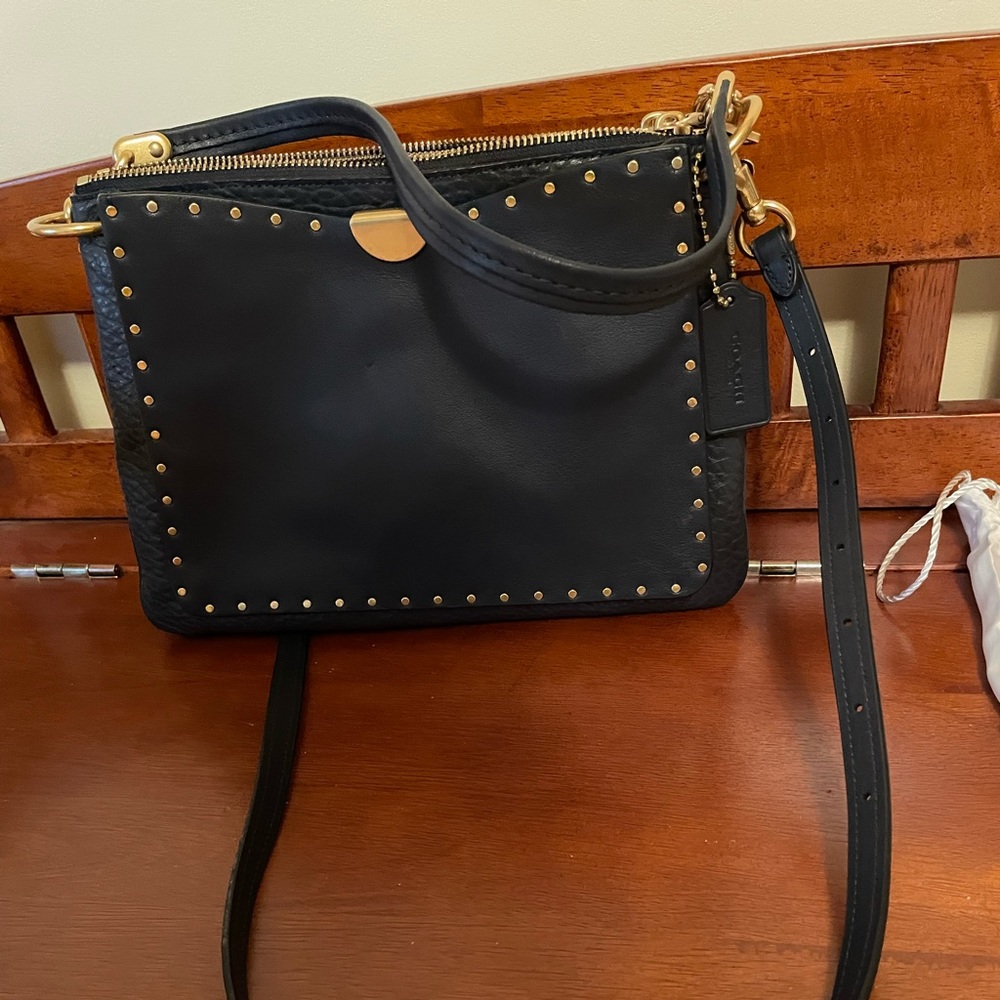 Gently used Coach Dreamer shoulder bag with rivets. Brass/Midnight Navy. 11Hx9W.